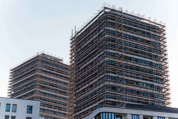 istock Two high-rise buildings under construction with full scaffolding. 2222037021