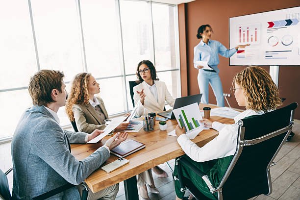 istock Group of diverse business professionals collaborating on a teamwork project in a modern office space with a presentation. 2222039592