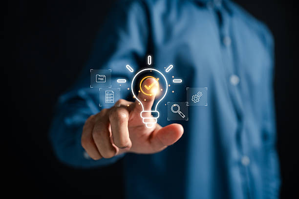istock Quick tip of Businessman touching glowing light bulb with checklist 2222043505
