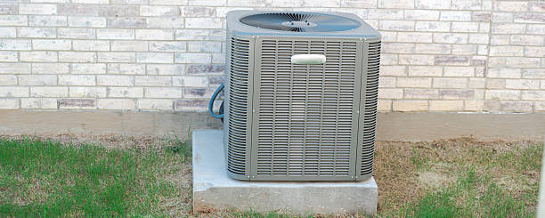 istock Panorama view outdoor HVAC unit and wall mounted electrical boxes installed along modern brick home, clean siding windows, grass landscaping shrub, privacy fence, disconnect switch, utility meter 2222043625