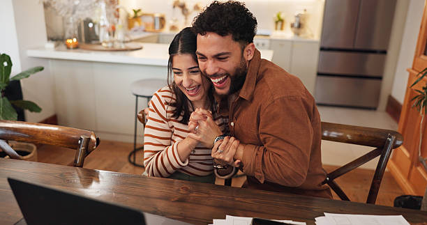 istock Couple, laptop and hug for success in home, reading loan application response and support with win. Happy people, embrace husband and email announcement for mortgage insurance, celebrate and love 2222050068
