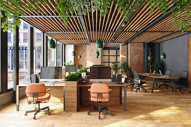 istock Sustainable open-plan modern office featuring desks, chairs, hanging lights, and plants 2222051579