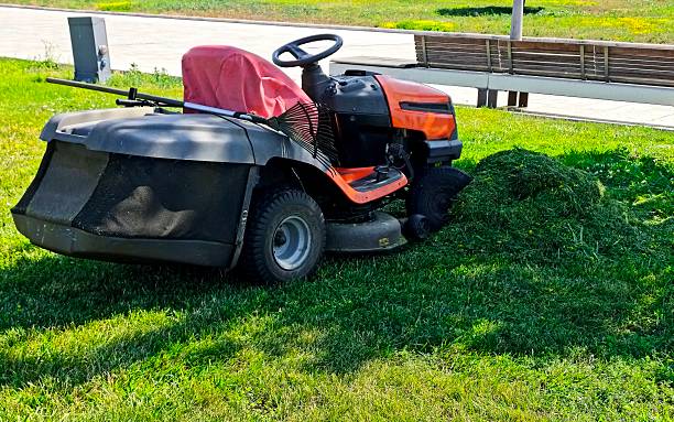 istock Lawn mower and cutted green fresh grass 2222054467