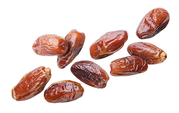 istock Dates fruits flying close-up on a white. Isolated 2222057988