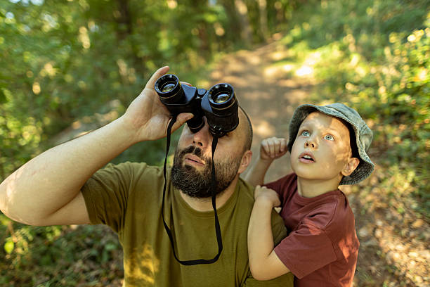 istock Father and son exploring birdlife, observing their movement and behavior in nature. 2222059490