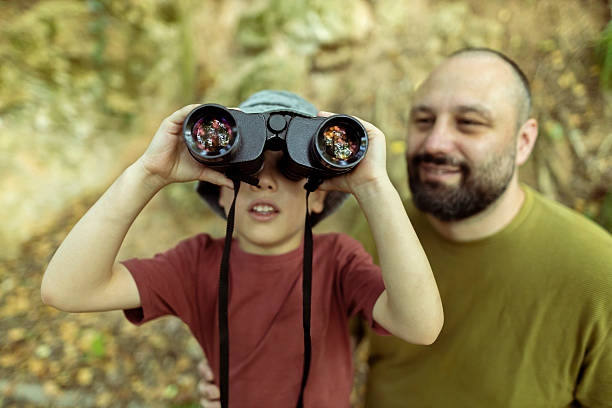 istock Father and son birdwatching together using binoculars. Quality time, bonding moment in nature. Close up photo 2222059538