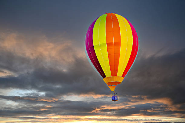 Colorful hot air balloon flying under the sunset sky