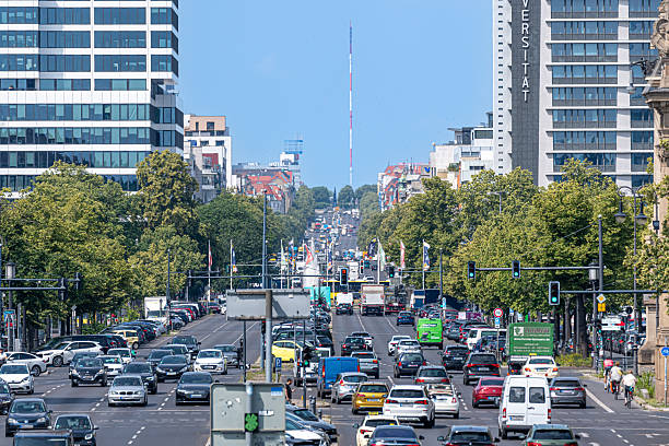 Germany, Berlin, Charlottenburg, Strasse des 17. Juni, June 18, 2025 - Road traffic with many vehicles like cars, trucks and bicycles  on the Strasse des 17. Juni. Office buildings and skyscrapers in the background near Ernst-Reuter-Platz.