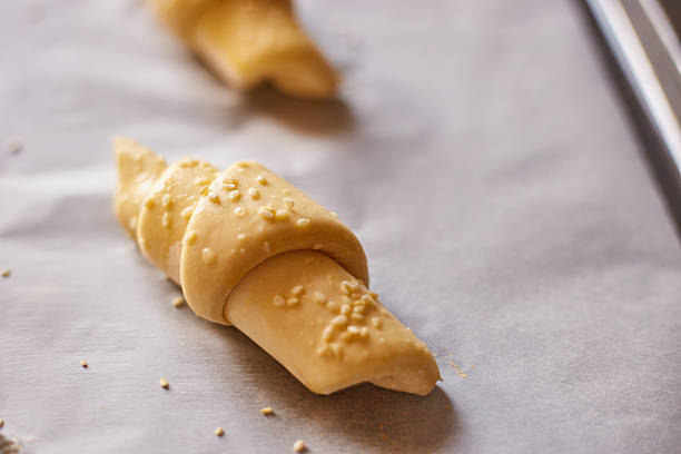 Perfectly shaped croissants ready for baking in a cozy kitchen setting at sunrise