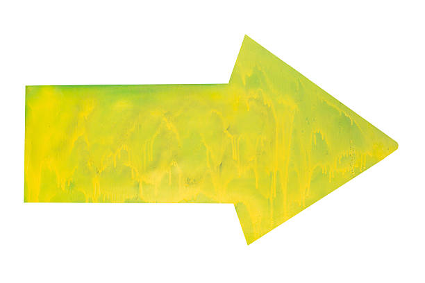 istock Drawn yellow arrow painted on green wall isolated on white background. 2222064367