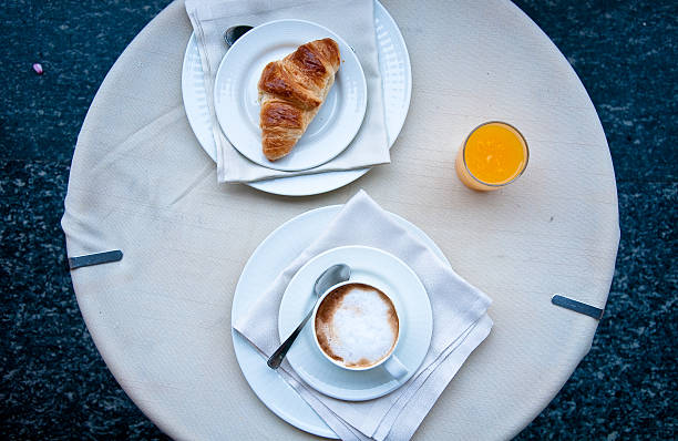 Fantastic breakfast of cappuccino, croissants , orange juice and biscuits