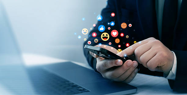 istock Close up man using smart phone with feedback icons of Social Media.Feedback or interactive with friends on chat or emoticon images appreciation. 2222066440