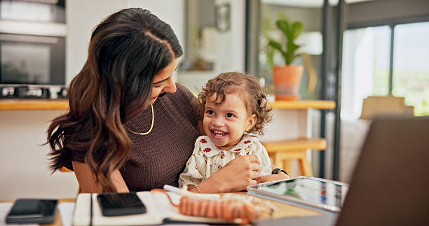 istock Laptop, multitasking or remote work with mother and baby in home for development of small business. Busy, computer or tablet with single parent and child in apartment for freelance or startup job 2222068437