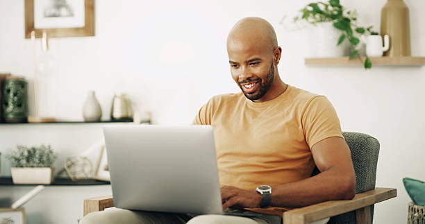 istock Remote work, laptop and man with smile for networking, research and planning with news source. Freelancer, male journalist and website with technology for article questions, information and home 2222069346