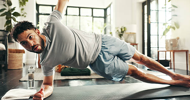 istock Fitness, man and side plank in home for exercise, training and stretching for balance. Core workout, muscle and strong person on floor for body strength, wellness and endurance challenge for pilates 2222069781