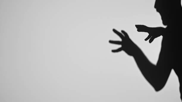 istock Intriguing Shadow Play with Hands and Human Silhouette 2222072375