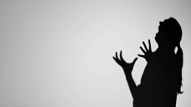 istock Silhouette of Person Expressing Emotion with Hands 2222075296