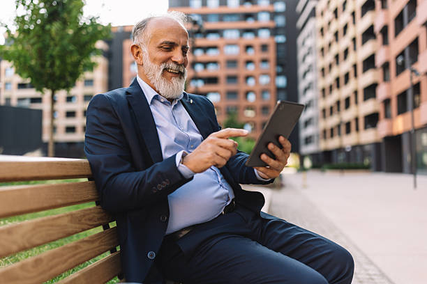 istock Senior Man with Tablet in Modern Urban Setting 2222075494