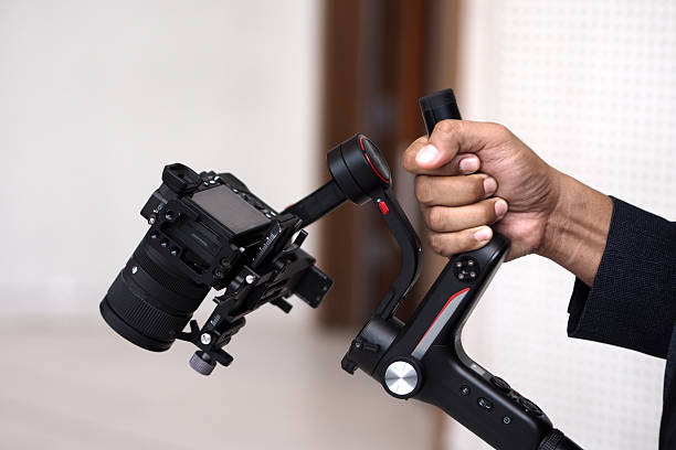 istock close up of hand holding camera and stabilizer 2222079974