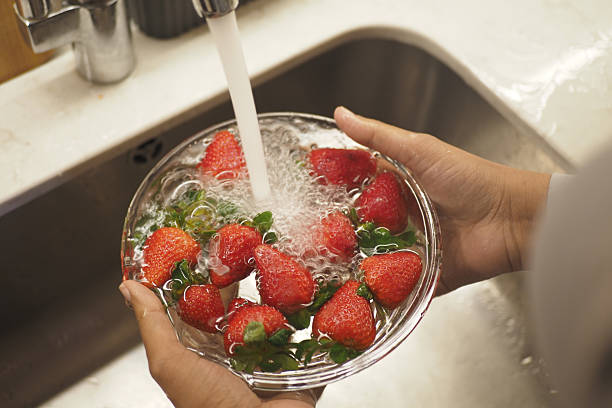 istock Cleaning Fresh strawberries at kitchen sink 2222082283