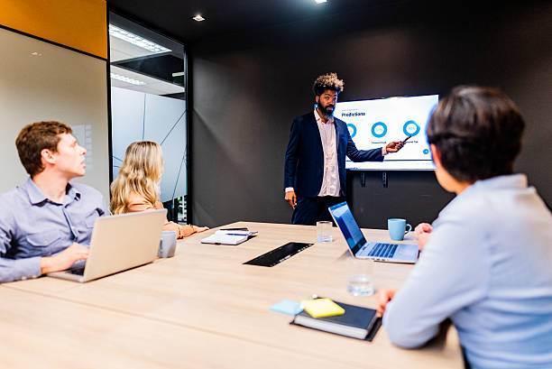 istock Businessman talking with coworkers on the office 2222083501