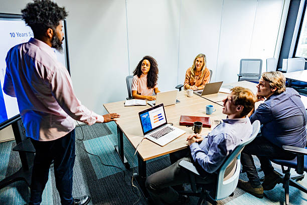 istock Businessman talking with coworkers on the office 2222083962