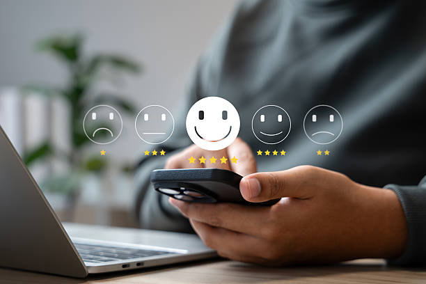 Customer satisfaction survey concept, Businessman using smartphone touch happy smiley icon, 5 star service experience rating, Feedback, Online review, Online application, Quality satisfaction review.