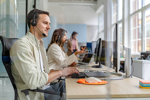 istock Modern office environment with young adults engaged in professional tasks and collaboration during work hours 2222085046