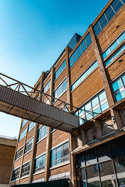 Low-angle view of a skybridge connecting two buildings in london, showcasing urban architecture and connectivity