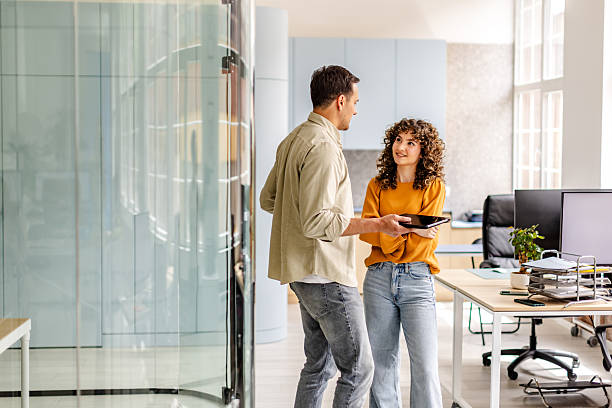 istock People engaging in conversation while enjoying a meal in a modern office setting during the day 2222085887