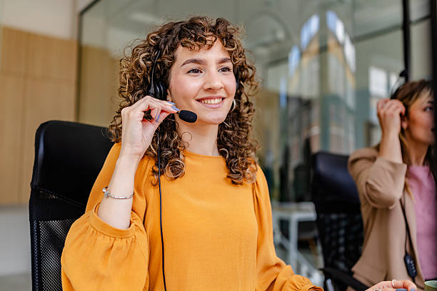 istock Professional young adults working in a modern office environment with headsets and focused expressions 2222086683