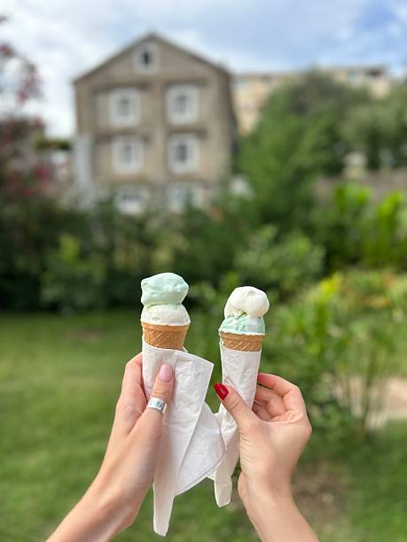 Enjoying ice cream cones in a sunny garden with mint and vanilla flavors
