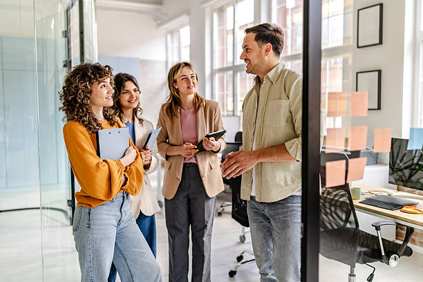 istock Team discussion and collaboration in a modern office setting with young professionals engaged in conversation 2222088068