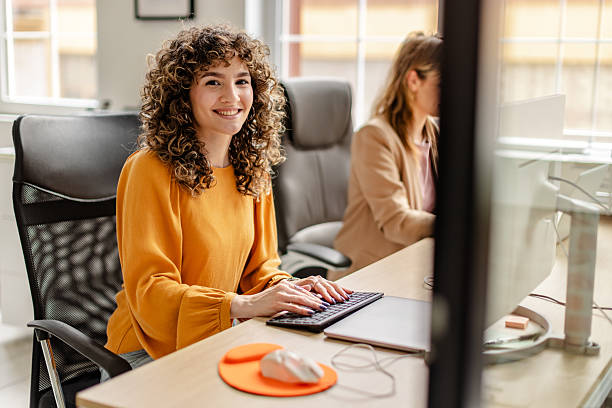 istock Team members engaged in productive work at a modern office with a bright and inviting atmosphere 2222088285