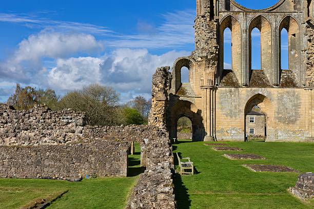 istock Ancient stone arches stand amid lush greenery, flanked by trees under a vivid blue sky 2222088473
