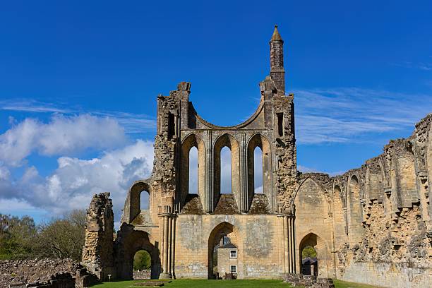 istock Majestic stone ruins with a towering central arch and pointed Gothic windows, partially crumbled yet grand 2222088517