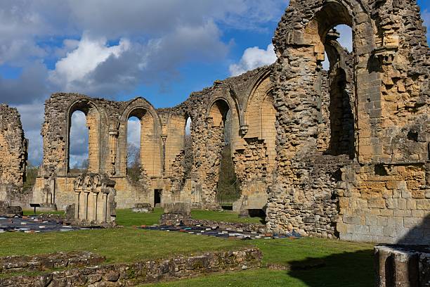 istock Tall, arched stone walls with crumbling edges frame the ruins of a historic structure 2222088676