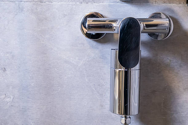 istock Sleek chrome shower water filter on a grey bathroom wall, symbolizing clean personal hygiene, healthy wellness, and modern home improvements with ample copy space 2222089267
