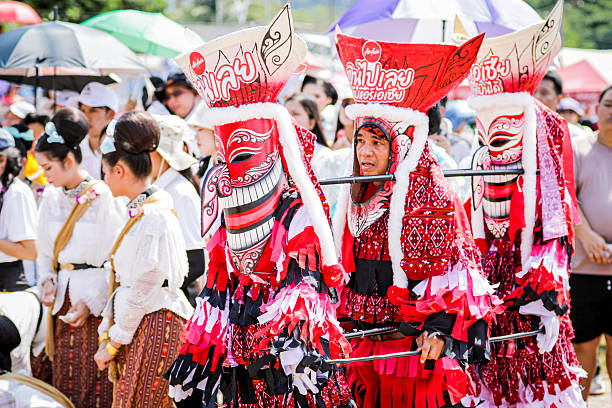 Loei, Thailand –July 8, 2024: Phi Ta Khon is the name of a mask performance in which performers wear scary and ugly but colorful masks, and wear colorful cloth costumes, and parade in a fun procession