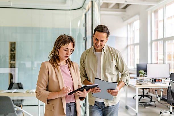 istock Collaboration in a modern office space with young adults reviewing project details during work hours 2222092747
