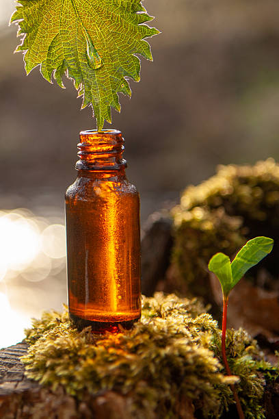 istock Amber glass bottle with leaf and drop 2222094223