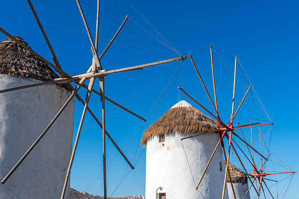 Windmills of Mykonos, Greece with a sun flair in the sky