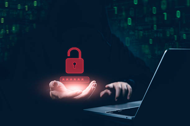 istock Cybersecurity threat concept. Hacker hand reveals glowing unlocked padlock and password, Digital crime warning data breach, cyber attack, and digital vulnerability in a dark internet security. 2222100590