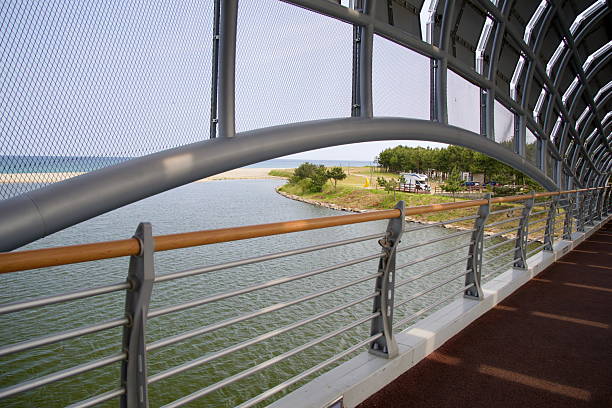 Uljin County, South Korea - May 31st, 2025: Looking out from the Sweet Fish Bridge, the Wangpi Stream curves gently toward its meeting with the East Sea, bordered by a grassy campground and coastal trees.
