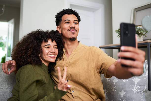 istock Smiling Couple Taking a Selfie in a Cozy Living Room Setting 2222101334