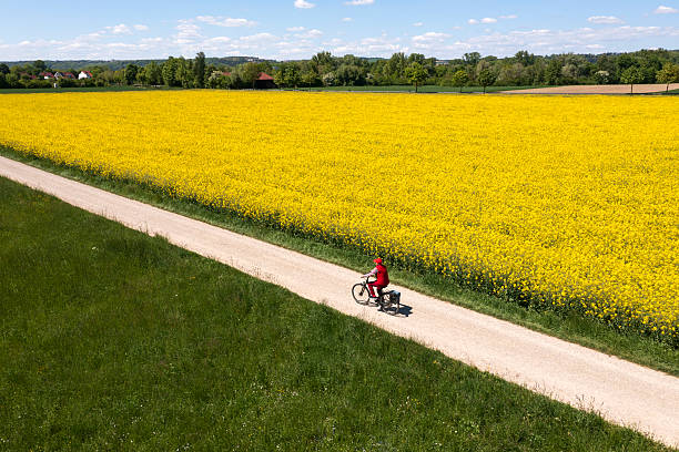 istock Woman riding bike in spring landscape 2222102764