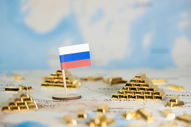 istock Russian flag prominently stands on a world map with gold bar stacks, symbolizing national wealth, global economic influence, and resource management, offering copy space 2222102811