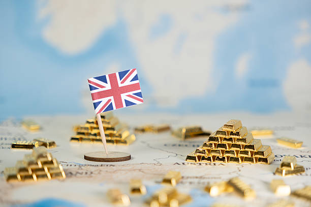 istock British flag on a world map surrounded by numerous gold bars, symbolizing global finance, investment, and the United Kingdom's economic position 2222103113