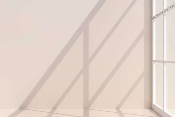 istock Sunlight casting geometric shadows on a beige wall near a window. 3d rendering 2222104938