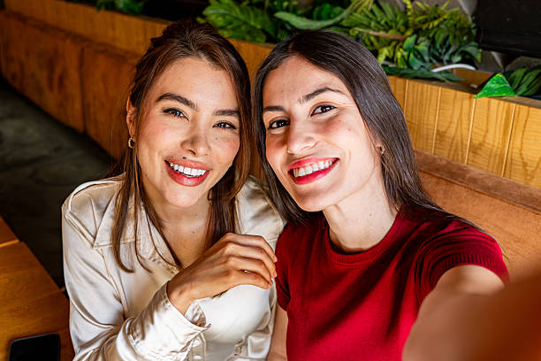istock Two Young Women Taking a Selfie in a Restaurant 2222106503